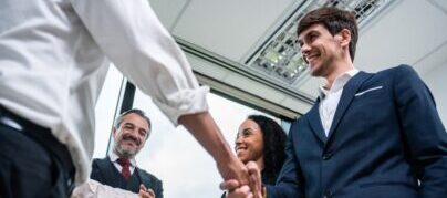 Caucasian businessman making a handshake together while stand in office.